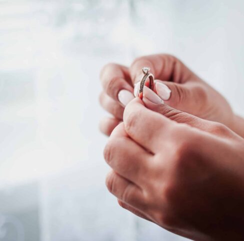 Bride hold gold diamond wedding ring in the hand