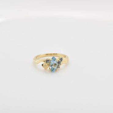 Marquise Aquamarine with aquamarine stones on a yellow gold band
